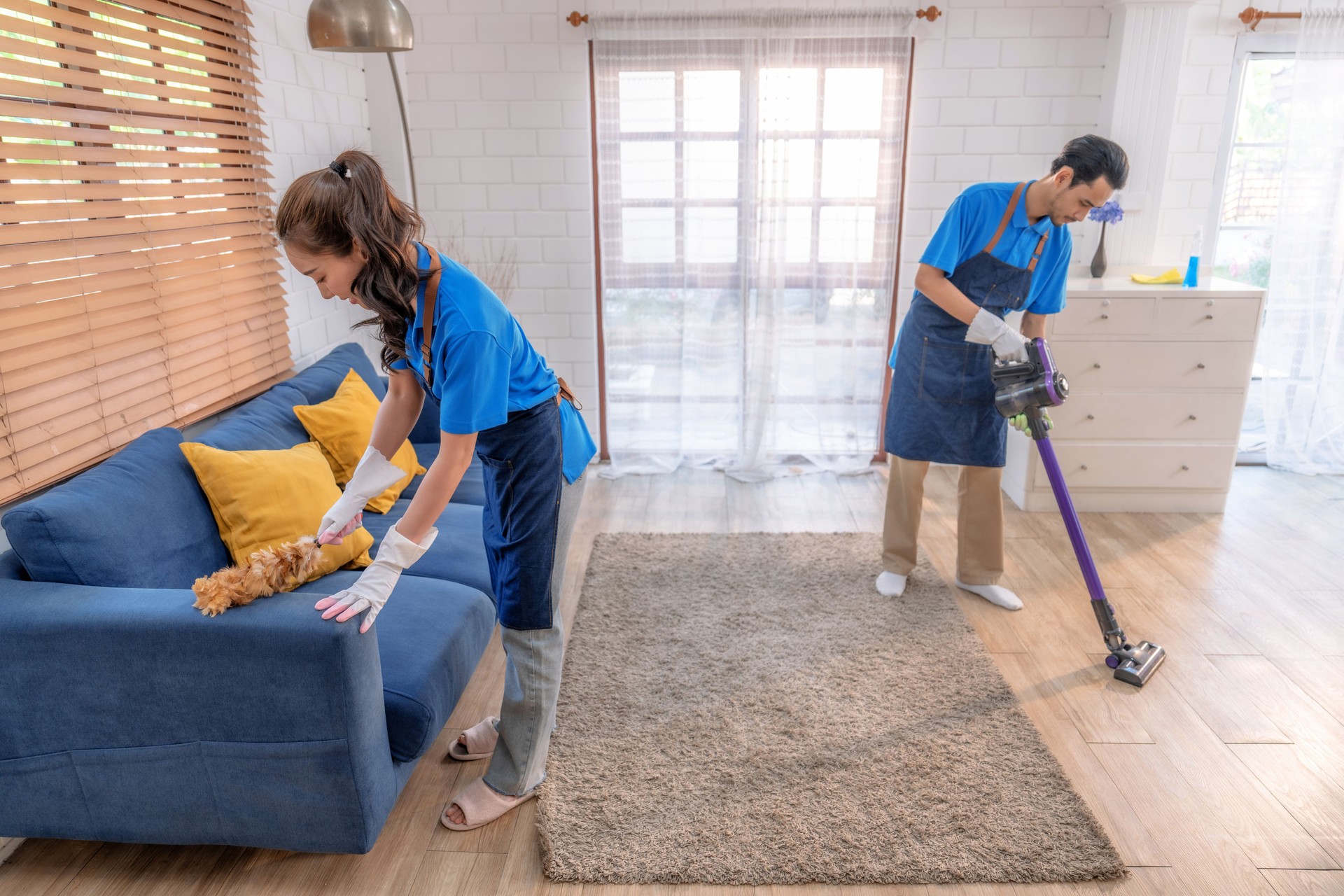 Male and female staff cleaning customers' homes. Male and female staff cleaning customers' homes.